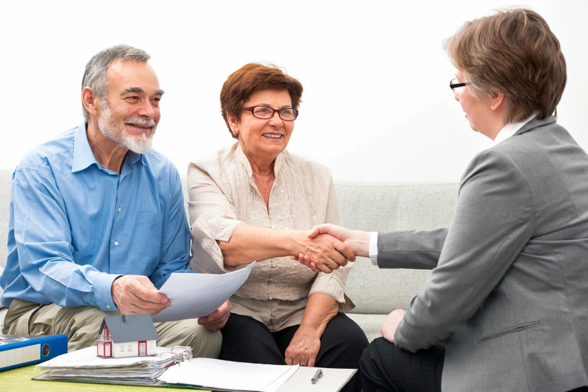 Seniors ouple meeting with financial adviser, handshake