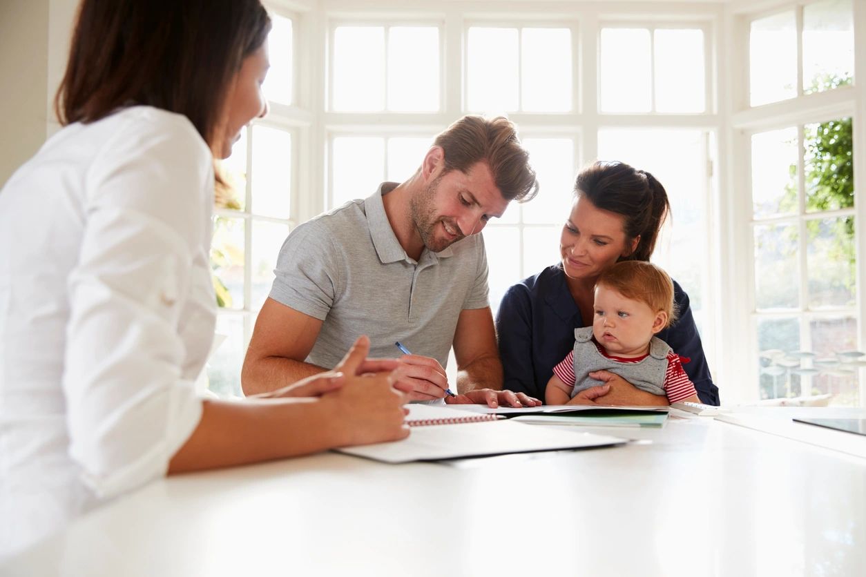 Couple meeting with financial adviser, handshake